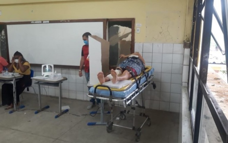 Eleitora leva queda em colégio eleitoral e vota carregada em maca