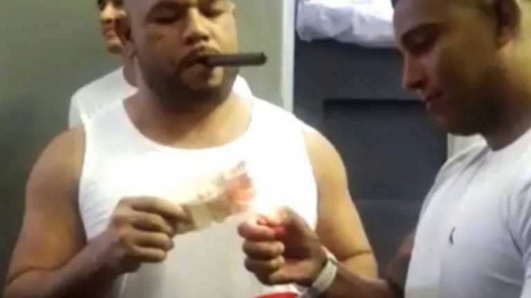 RJ: Detentos usam notas de R$ 50 para acender charutos em presídio; assista